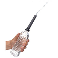Enema nozzle attached to a standard water bottle, demonstrating water flow through the tip