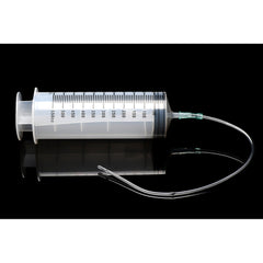 Enema syringe with attached flexible silicone tube, shown on reflective dark surface