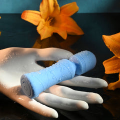 Evolved mini wand resting on a hand covered in water droplets, showing waterproof design