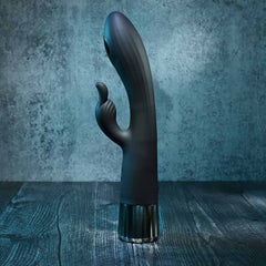 Evolved rabbit vibrator standing upright on wood surface, curved tip and arm visible