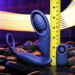 Extra Mile prostate massager shown beside a ruler measuring approximately 5 inches tall with remote
