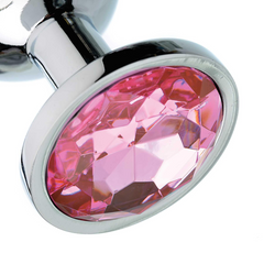Close-up of faceted pink crystal base on a stainless steel anal plug, oval gem in silver setting