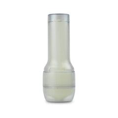 Feel Glow stroker standing upright outside packaging, clear cylindrical case with pale luminescent inner sleeve