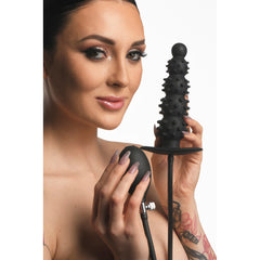 Female model displaying the nubbed black silicone plug and soft squeeze pump bulb