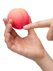 Finger pointing to the air-pulse opening on the bottom of the Pink Peach stimulator