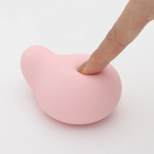 Finger pressing into soft flexible silicone surface of the MIDORI Nadeshiko, showing pliability