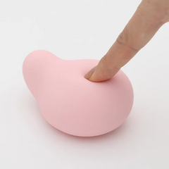Finger pressing into soft flexible silicone surface of the MIDORI Nadeshiko, showing pliability