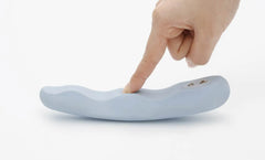 Finger pressing the touch-sensitive control surface of the blue silicone MINAMO