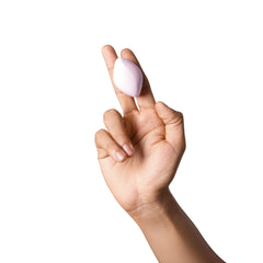 Finger wearing Dame Fin 2.0 vibrator on fingertip, demonstrating wearable ring fit