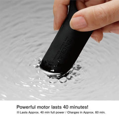 Fingertip pressing black vibrating ring into water ripples, motor lasts up to 40 minutes
