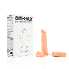 Finished light-tone silicone replica dildo with balls and wired vibrator beside Empire Labs packaging