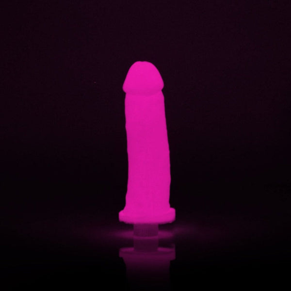Finished pink glow-in-the-dark silicone dildo illuminated against a dark background