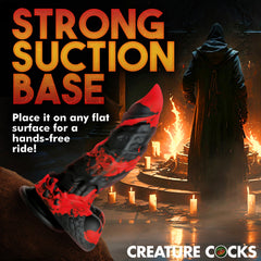Fire Demon dildo mounted via strong suction base on a surface for hands-free use positioning
