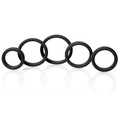 Five black silicone cock rings arranged by ascending diameter, displaying smooth flexible construction and consistent ring