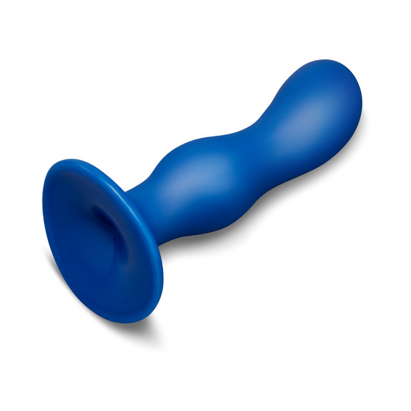 Flat lay of b-Vibe Milk anal trainer showing suction cup underside and overall body length