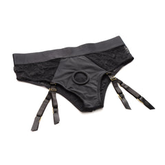 Flat lay of black lace panty harness with visible O-ring and four adjustable garter straps
