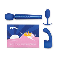 Flat lay of Le Wand massager, blue silicone plug, curved attachment, and b-Vibe pleasure guide