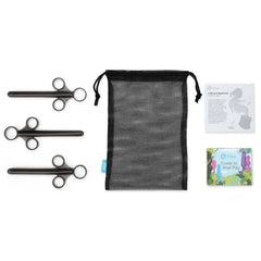 Flat lay of three black applicators, mesh bag, user guide, and anal play booklet