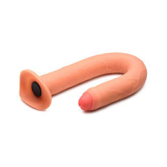 Flexible flesh-tone silicone enema hose bent into U-shape showing suction base connector port