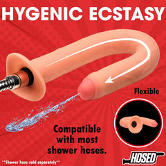 Flexible silicone enema hose connected to shower hose, demonstrating bend and water flow