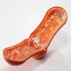 Flip Orb inner sleeve laid open flat, revealing intricate spiral and floral texture pattern in orange