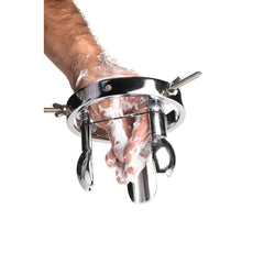 Forced Spread speculum shown with lubricant applied to wrist, demonstrating prep step