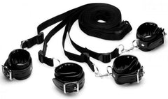 Four black faux-leather cuffs with silver hardware and long nylon tether straps arranged flat