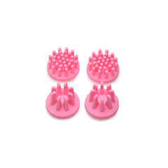 Four pink silicone replacement attachments with varied pin and nub textures, top view
