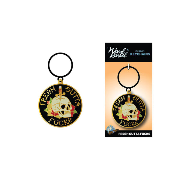 Fresh Outta Fucks skull keychain shown beside its branded Wood Rocket enamel keychains retail card