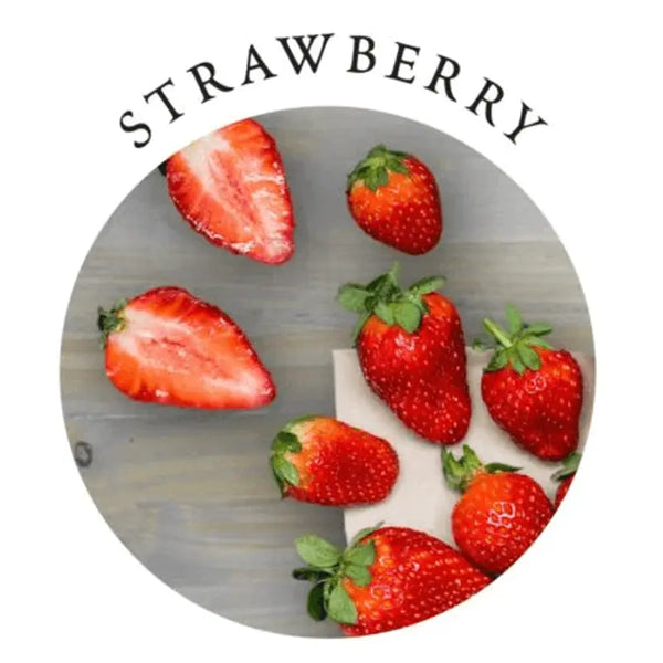 Fresh strawberries arranged on a grey surface, highlighting the Strawberry massage candle fragrance