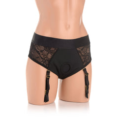 Front view of black lace crotchless panty harness with gold garter strap hardware on mannequin