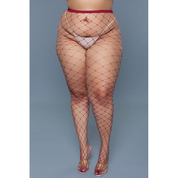 Front view of burgundy large-weave fishnet pantyhose with sheer coverage, styled with clear heels