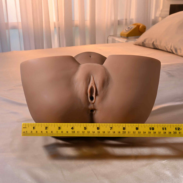 Front view of dark-tone stroker beside a ruler showing approximately 12-inch width for size reference