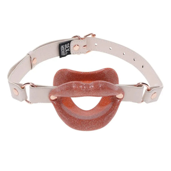 Front-facing display of glitter silicone lips gag on fully assembled cream adjustable harness