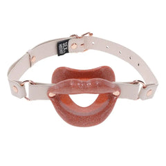 Front-facing display of glitter silicone lips gag on fully assembled cream adjustable harness