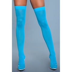 Front-facing lifestyle view of opaque nylon thigh highs in vibrant turquoise with open-toe heels