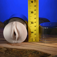 Front-facing stroker in canister beside ruler showing approximately 3.5 inch width