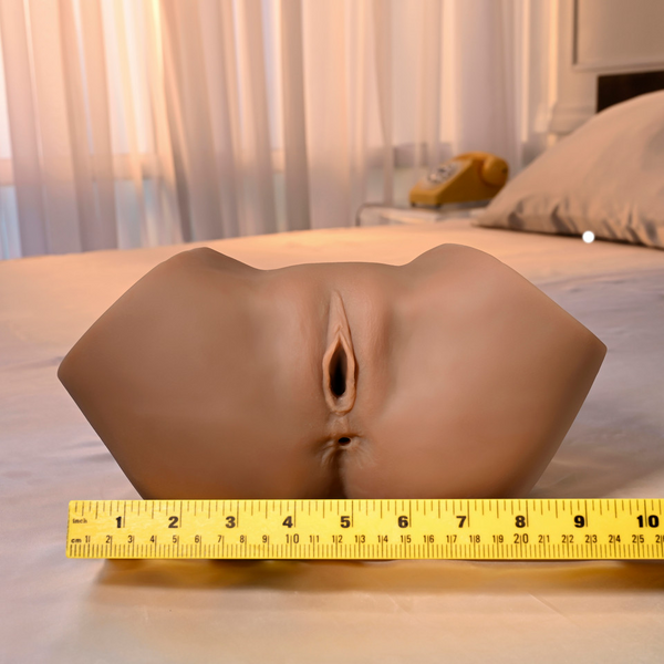 Front view of realistic stroker with a standard tape measure showing approximately 10-inch width