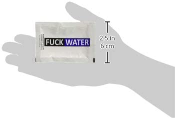 FuckWater lube foil packet resting on a hand showing compact 2.5-inch size