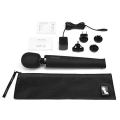 Full contents of Le Wand massager kit: device, charger, adapters, pouch, and guides