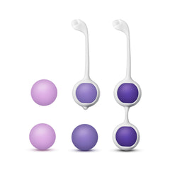 Full kit layout showing two harness trainers and four loose silicone balls in two shades of purple