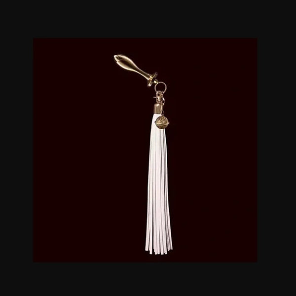 Full side profile of white leather tassel attached to gold rose plug, displaying complete kit length and component arrangemen