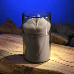 Full view of stroker secured inside clear glass canister, illuminated from below