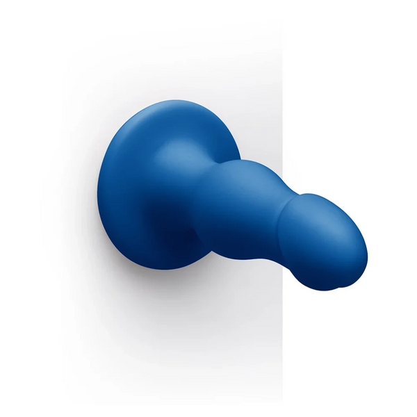 Gape dildo mounted via suction cup on flat surface, demonstrating hands-free use