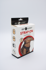 Get Lucky Strap-On Harness box angled to reveal side feature icons and lifestyle photo of harness worn