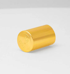 Gold embossed cap of Stud 100 spray lying on its side showing the branded Stud logo