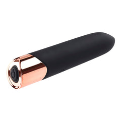 The Gold Standard vibrator lying flat highlighting rose gold end cap with centered power button