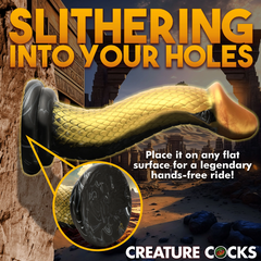 Golden Mamba dildo mounted on flat surface via suction base, showing hands-free use capability