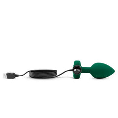 Green silicone anal plug connected to USB magnetic charging cable by b-Vibe