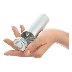 Hand demonstrating how the butt plug separates from its storage canister, showing magnetic base
